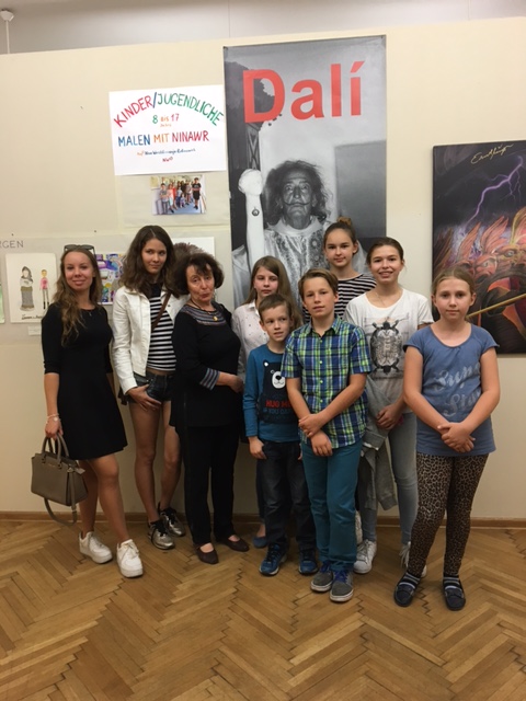 Photo with the group of students under the poster
