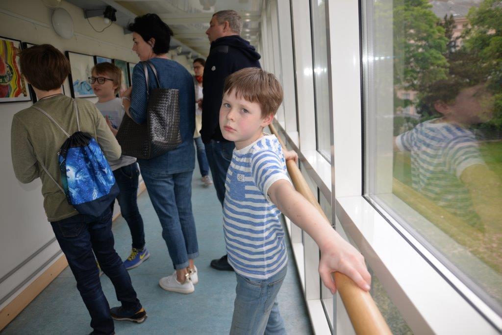 Students and their parents are   looking at the drawings at the gallery